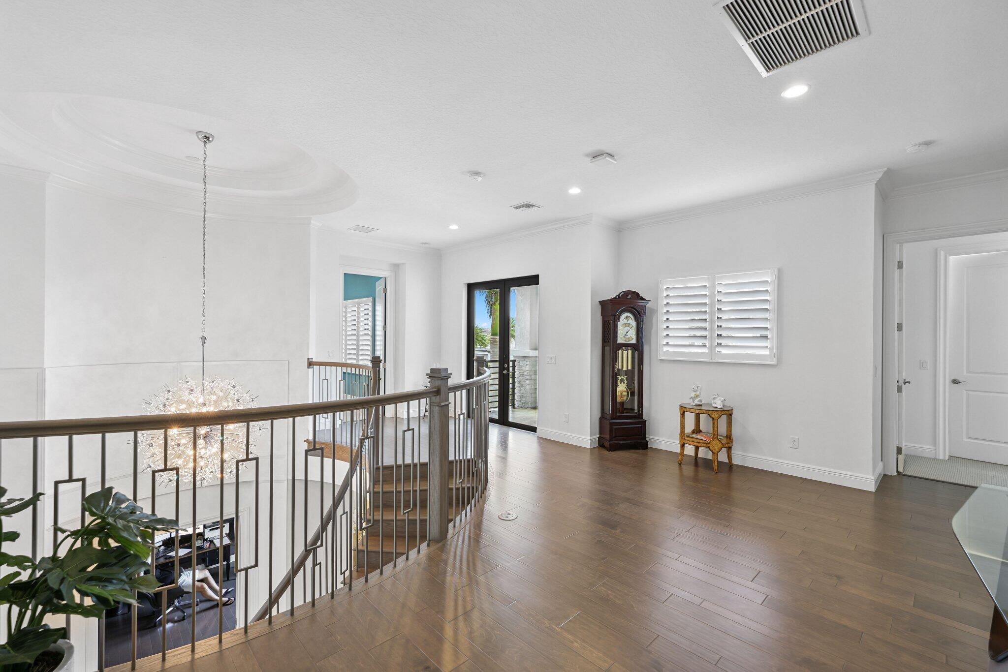2741 Northwest 70th Boulevard Boca Raton, FL 33496 - Photo 73 of 109 a view of a hallway with wooden floor and windows