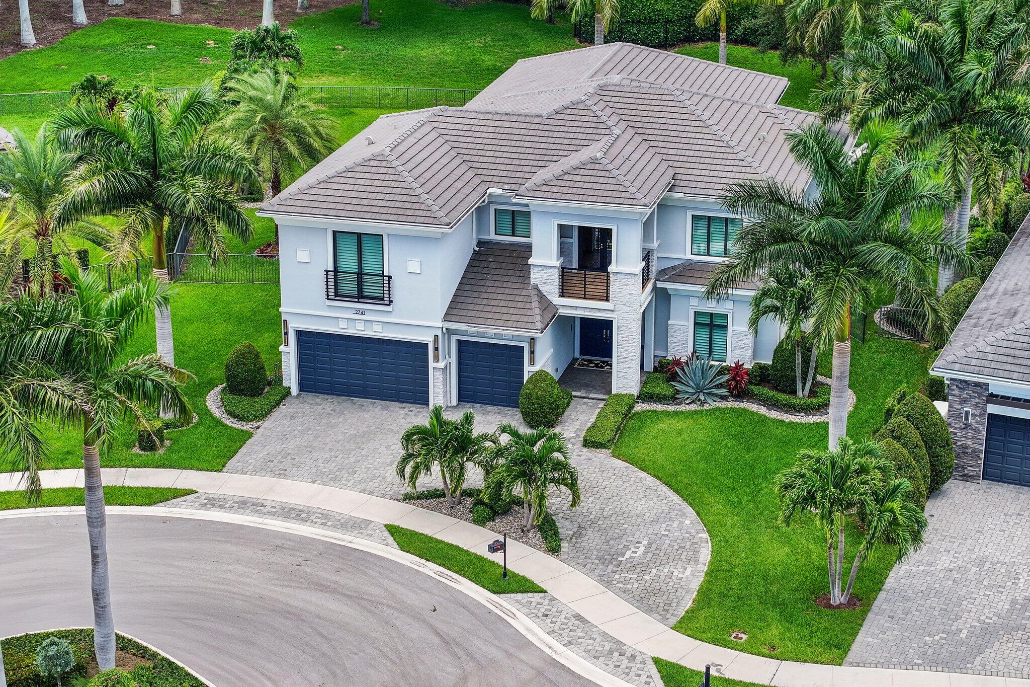2741 Northwest 70th Boulevard Boca Raton, FL 33496 - Photo 79 of 109 a front view of a house with a yard and potted plants