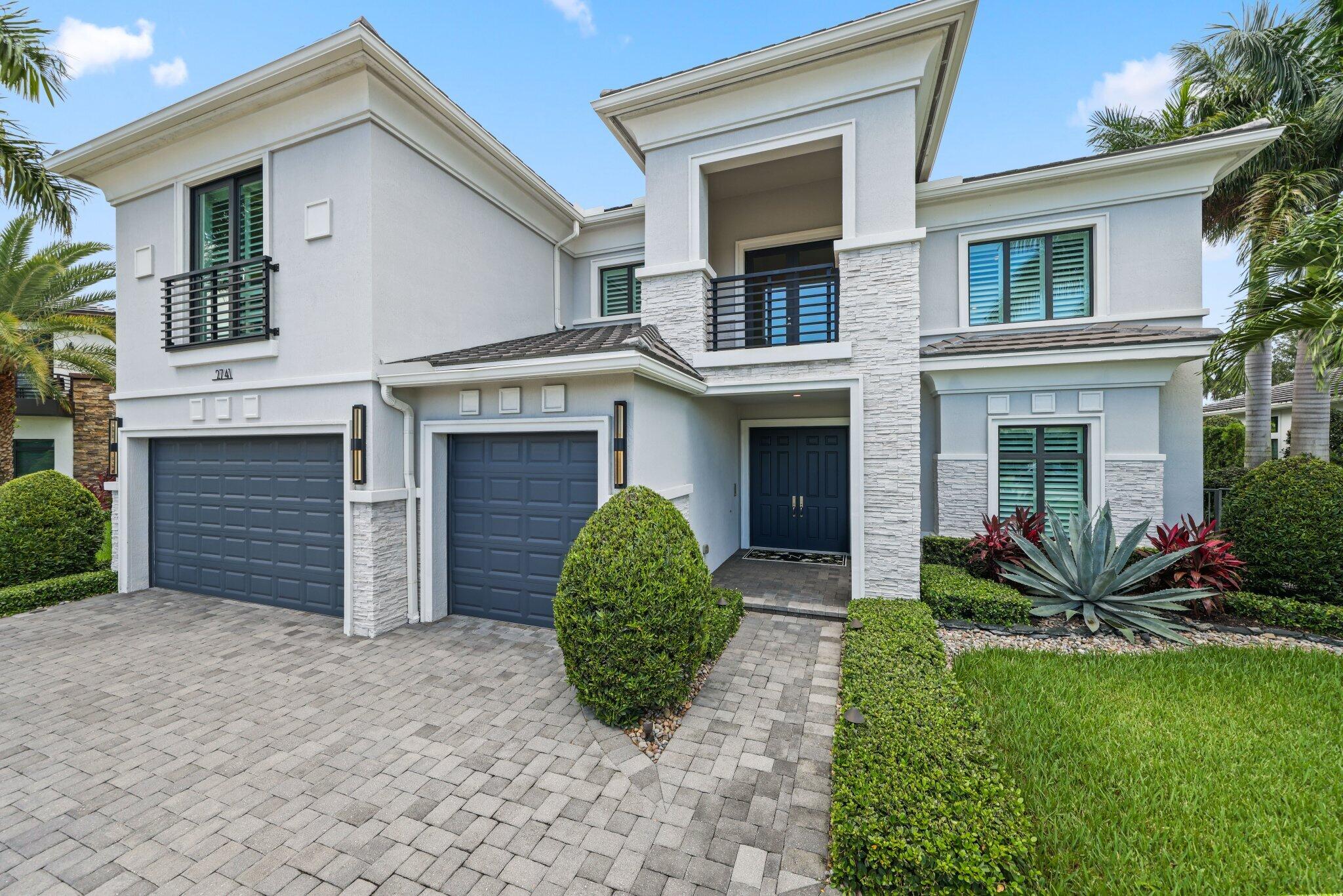 2741 Northwest 70th Boulevard Boca Raton, FL 33496 - Photo 8 of 109 front view of a house with a yard