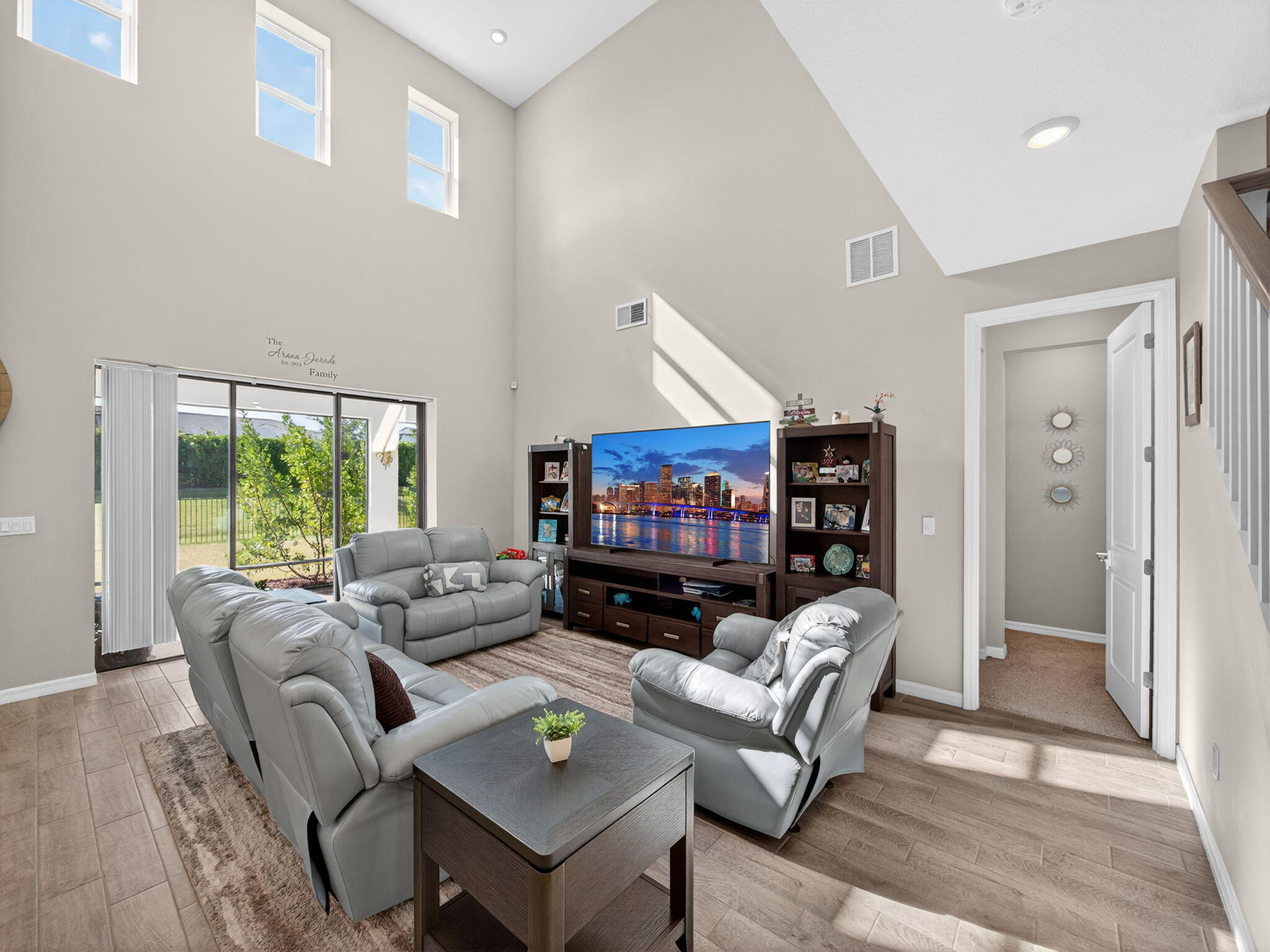 11912 Southwest Macelli Way Port Port St. Lucie, FL 34987 - Photo 13 of 34 a living room with furniture a rug and a flat screen tv