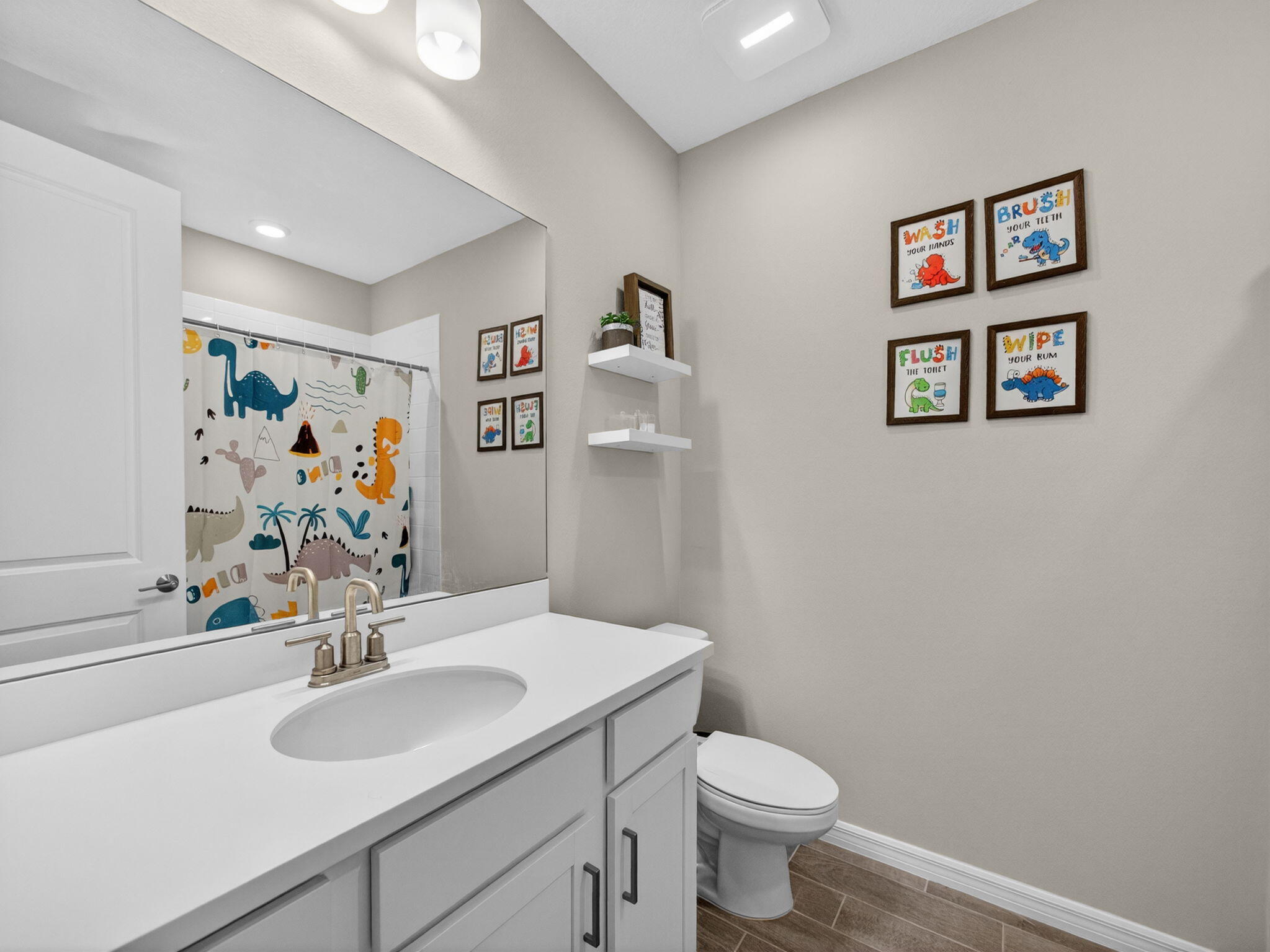 11912 Southwest Macelli Way Port Port St. Lucie, FL 34987 - Photo 21 of 34 a bathroom with a sink mirror and toilet