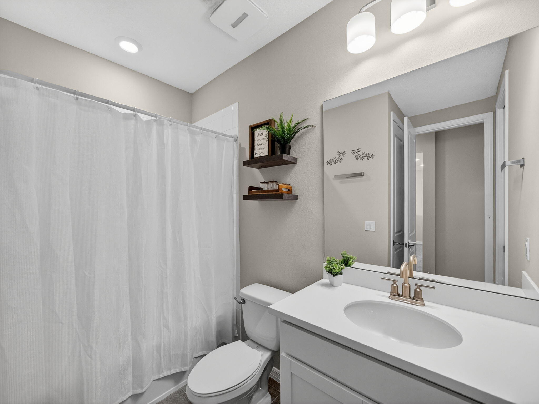 11912 Southwest Macelli Way Port Port St. Lucie, FL 34987 - Photo 23 of 34 a bathroom with a sink vanity mirror and toilet