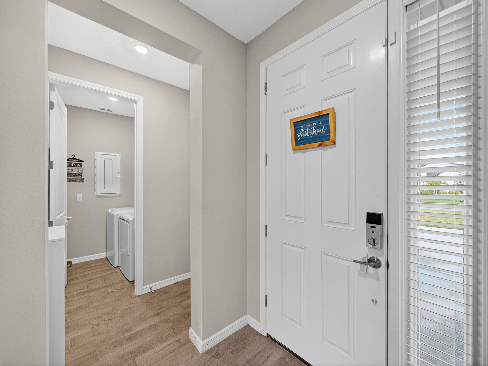11912 Southwest Macelli Way Port Port St. Lucie, FL 34987 - Photo 25 of 34 a view of a hallway with wooden floor and a bathroom