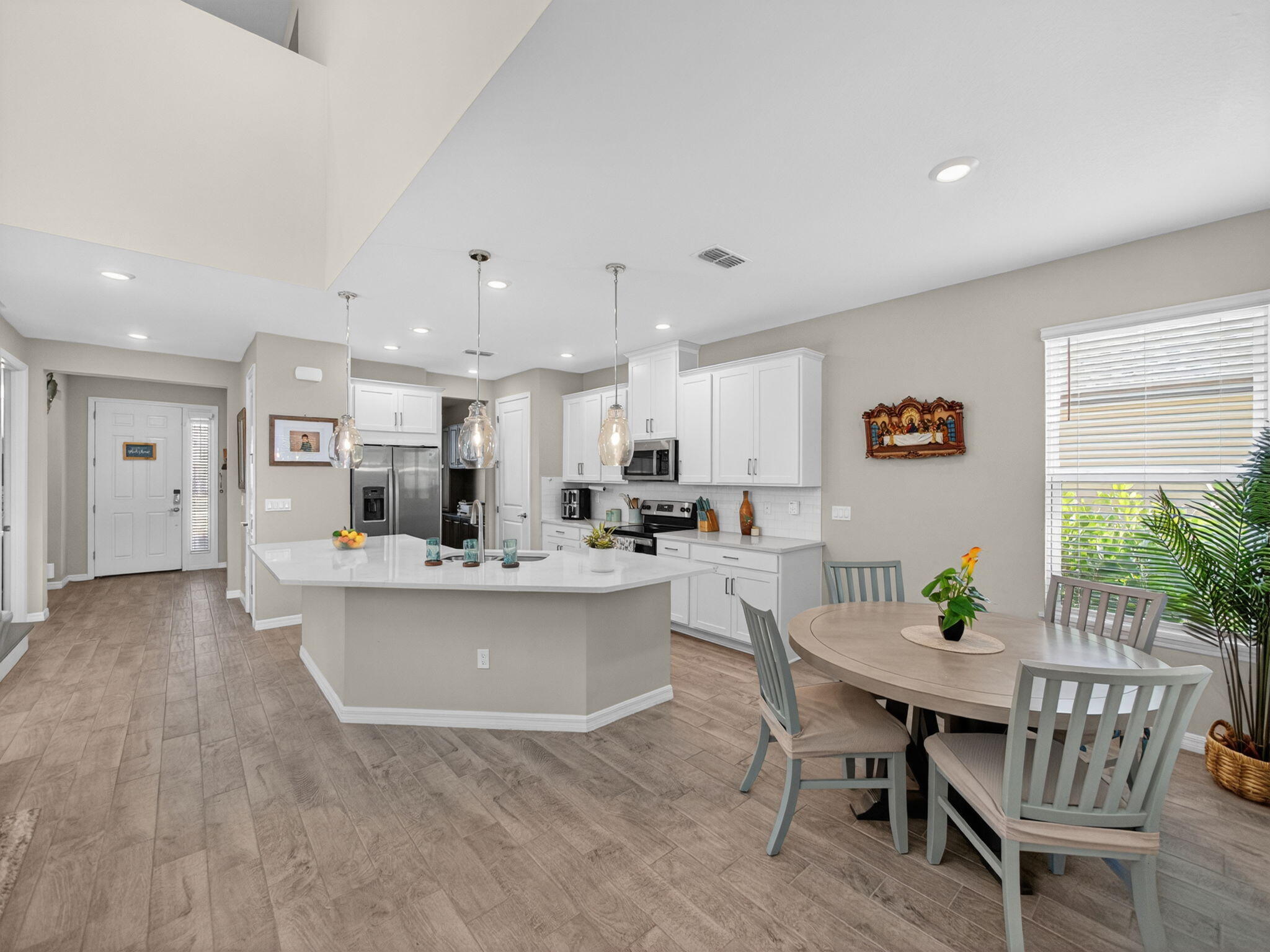 11912 Southwest Macelli Way Port Port St. Lucie, FL 34987 - Photo 8 of 34 a view of a dining room with furniture and wooden floor