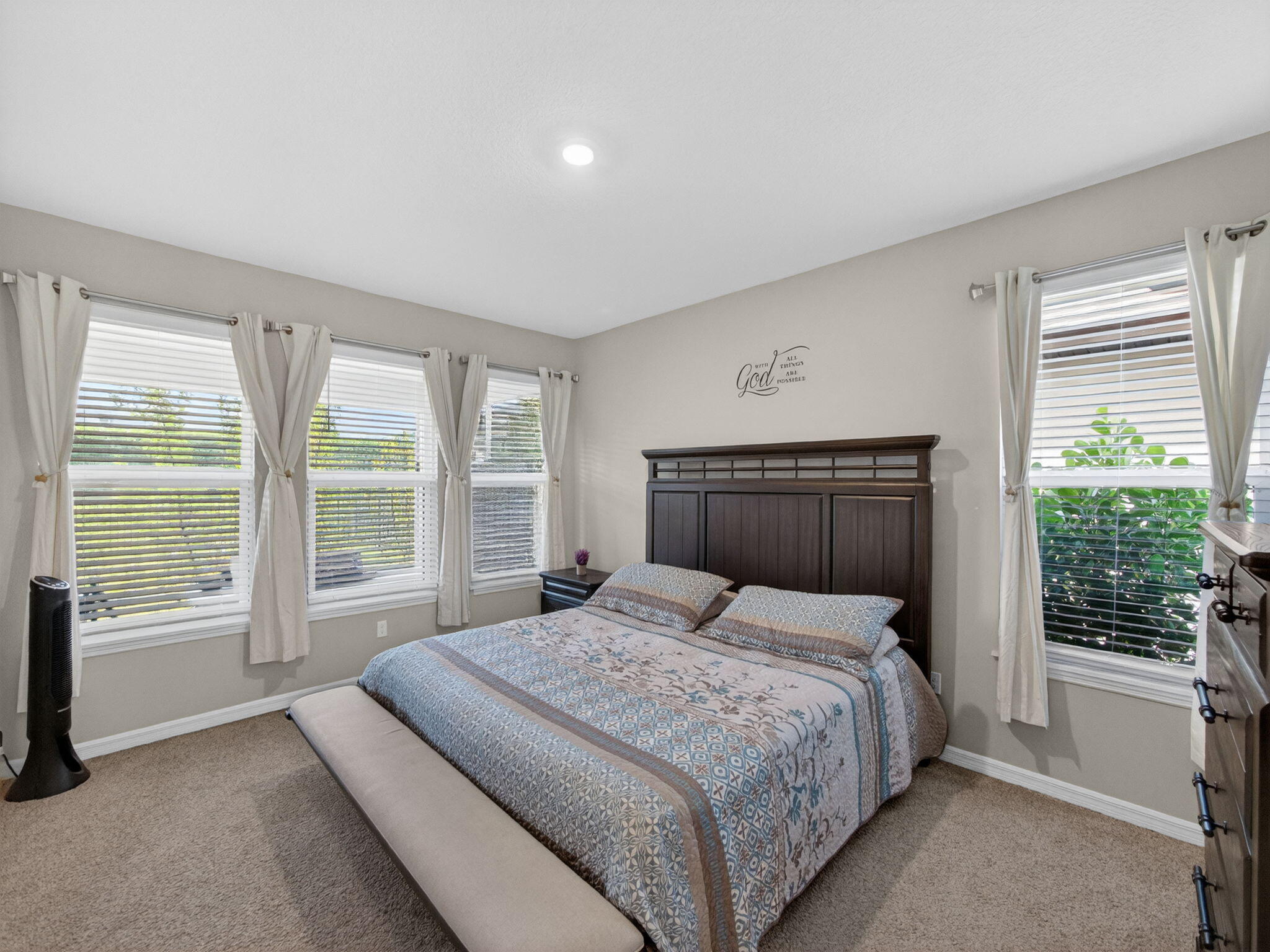 11912 Southwest Macelli Way Port Port St. Lucie, FL 34987 - Photo 10 of 34 a bedroom with a large bed and a large window