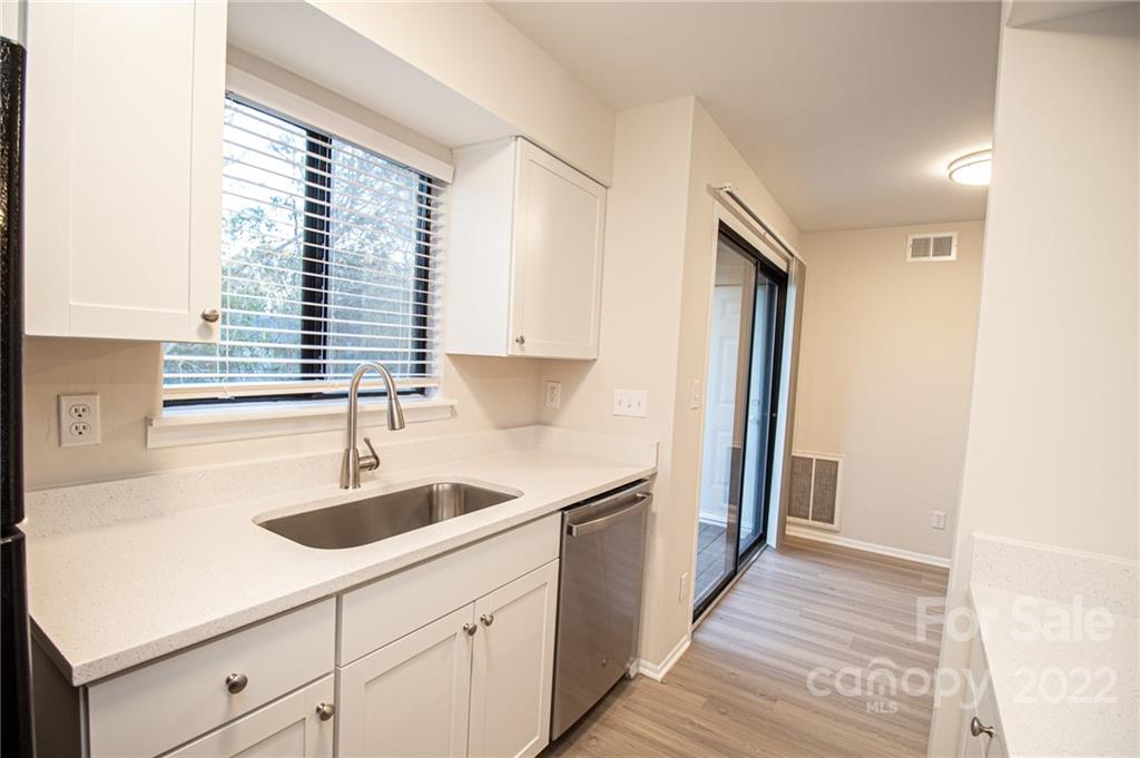 11039 Cedar View Road Charlotte, NC 28226 - Photo 11 of 24 a kitchen with a sink and a window