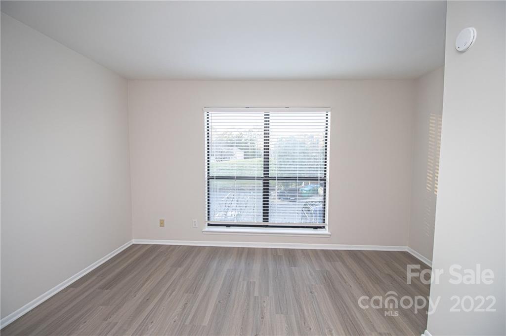 11039 Cedar View Road Charlotte, NC 28226 - Photo 18 of 24 an empty room with wooden floor and windows