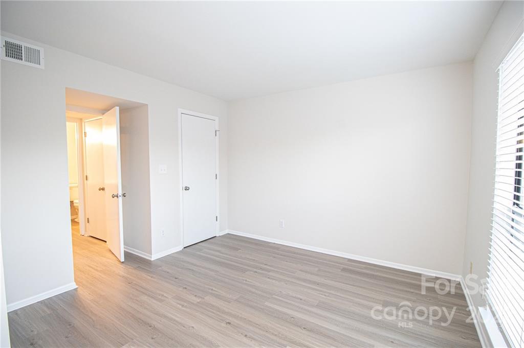 11039 Cedar View Road Charlotte, NC 28226 - Photo 19 of 24 an empty room with wooden floor and windows