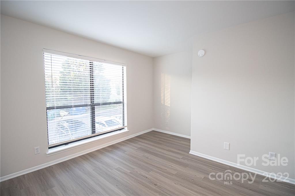 11039 Cedar View Road Charlotte, NC 28226 - Photo 20 of 24 an empty room with wooden floor and windows