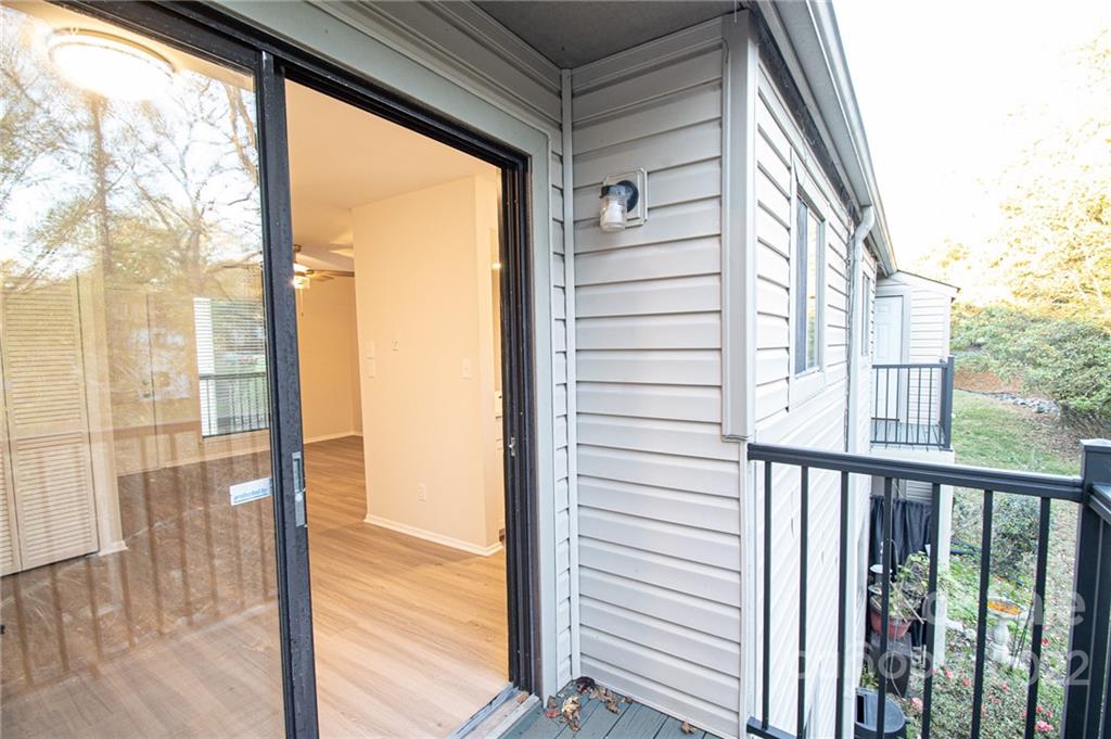 11039 Cedar View Road Charlotte, NC 28226 - Photo 22 of 24 a view of a balcony with floor to ceiling window wooden floor and fence