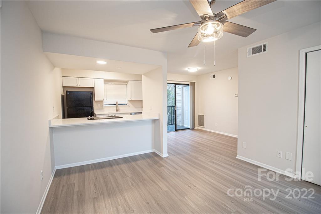 11039 Cedar View Road Charlotte, NC 28226 - Photo 3 of 24 a view of a kitchen with a sink and a refrigerator