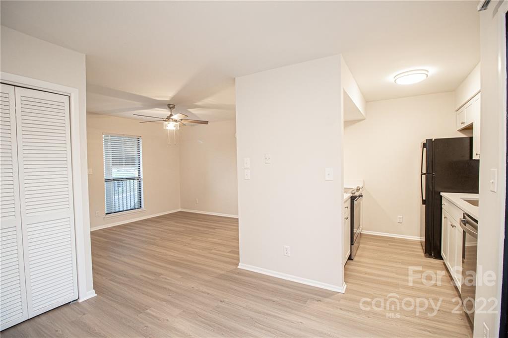 11039 Cedar View Road Charlotte, NC 28226 - Photo 5 of 24 an empty room with wooden floor and a ceiling fan