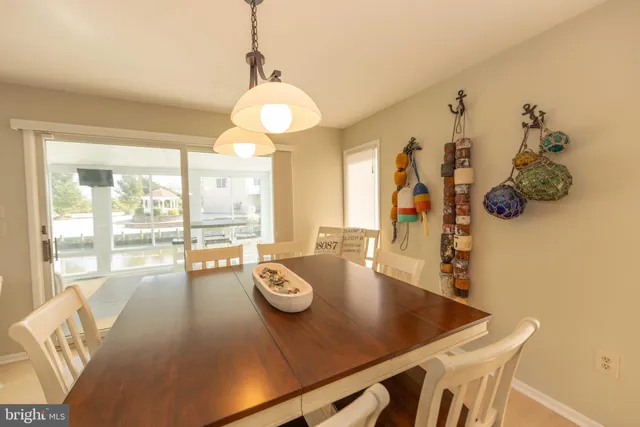 a kitchen with a refrigerator a sink and dishwasher with white cabinets