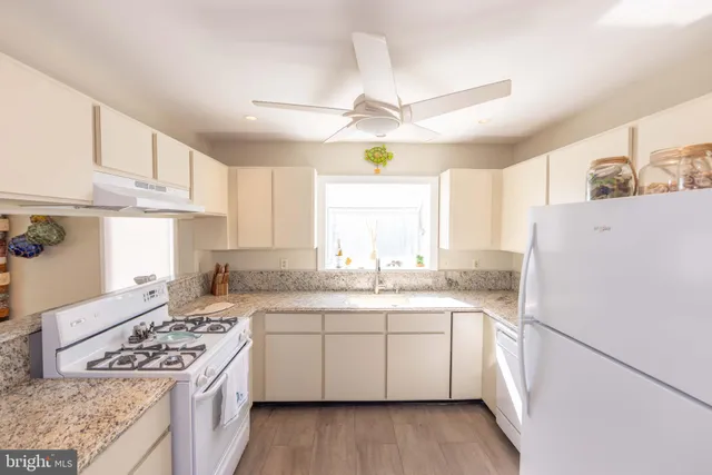 a living room with furniture wooden floor and a large window