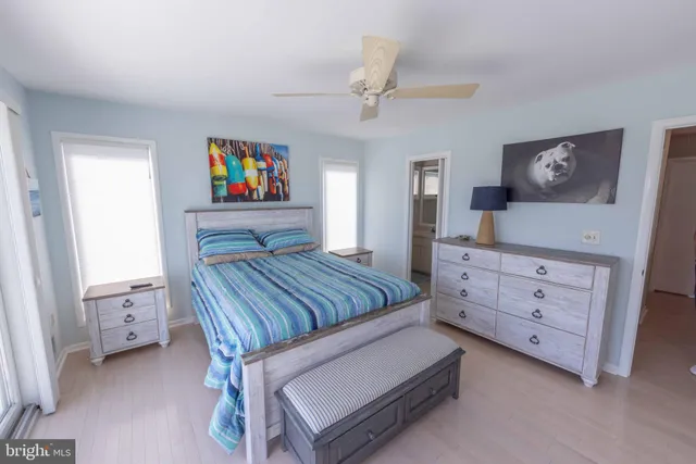 an aerial view of ocean and residential houses with outdoor space
