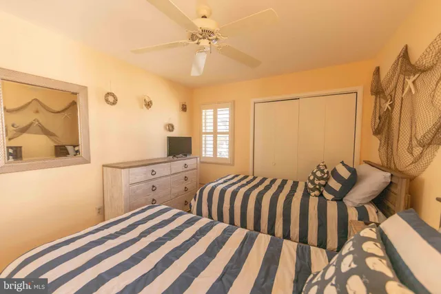 an aerial view of a city with lots of residential buildings and ocean view in back