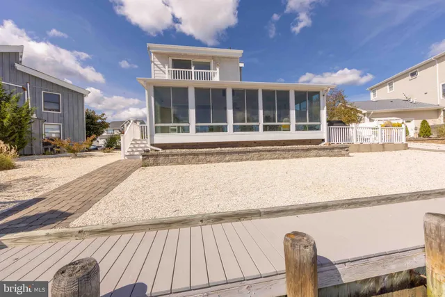 a view of a patio with a dining table and chairs under an umbrella