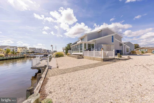 a view of a balcony with lake view and floor to ceiling windows