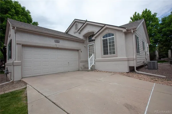 a view of house with outdoor space and parking space