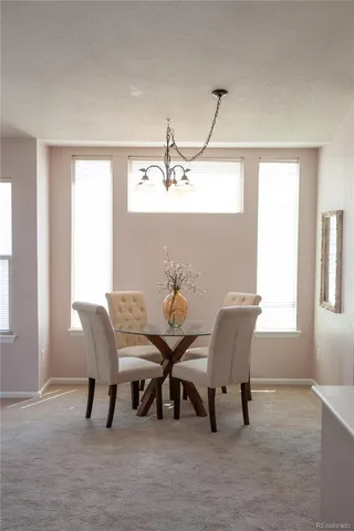 a view of a dining room with furniture and window