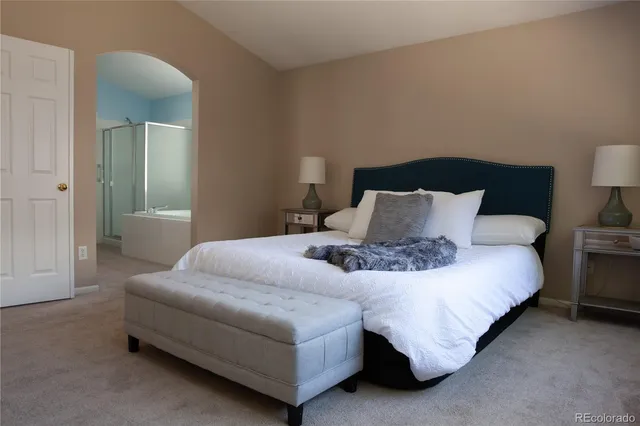 a bedroom with a bed and lamp