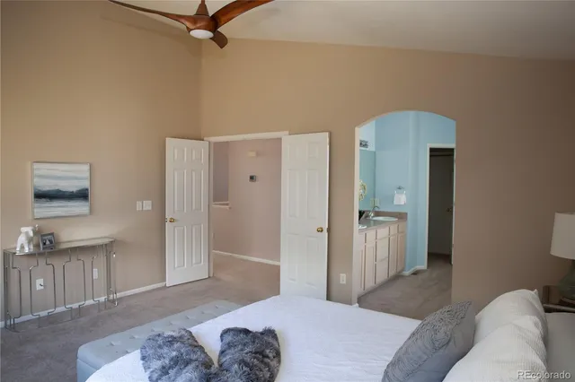 a bedroom with a bed and a couch