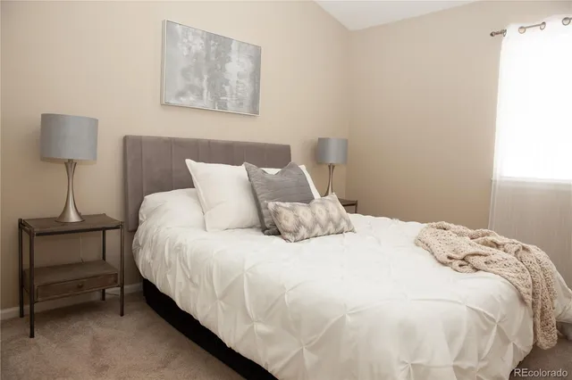 a bedroom with a bed and a lamp