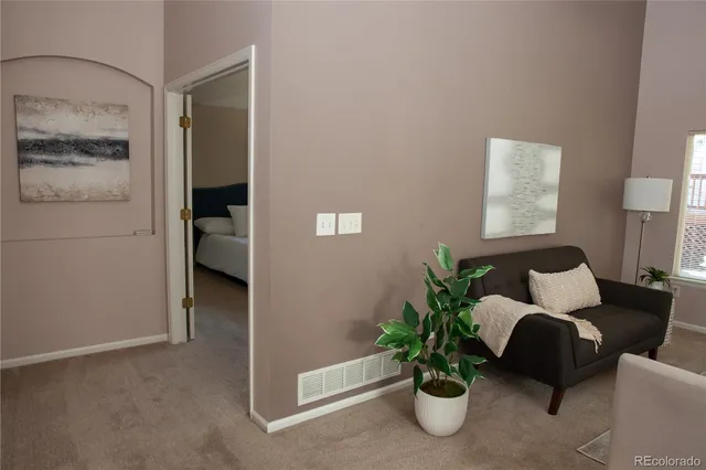 a living room with furniture flowerpot and a potted plant