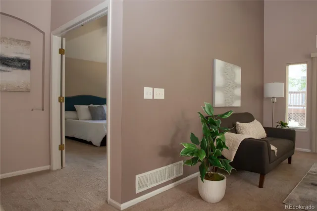 a living room with furniture and a potted plant