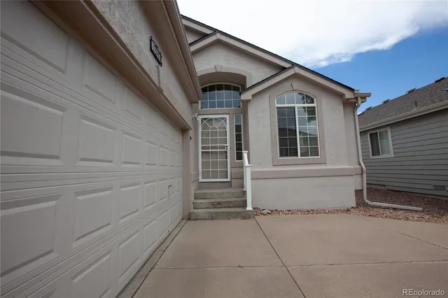 a front view of a house with a garage