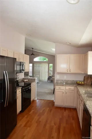 a kitchen with stainless steel appliances granite countertop a stove top oven a sink and dishwasher