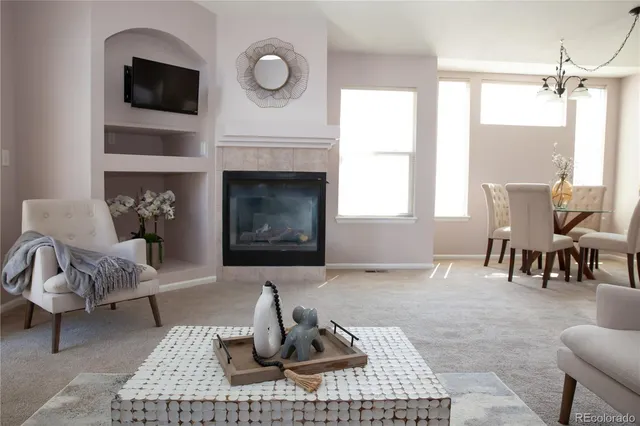 a living room with furniture a window and a fireplace