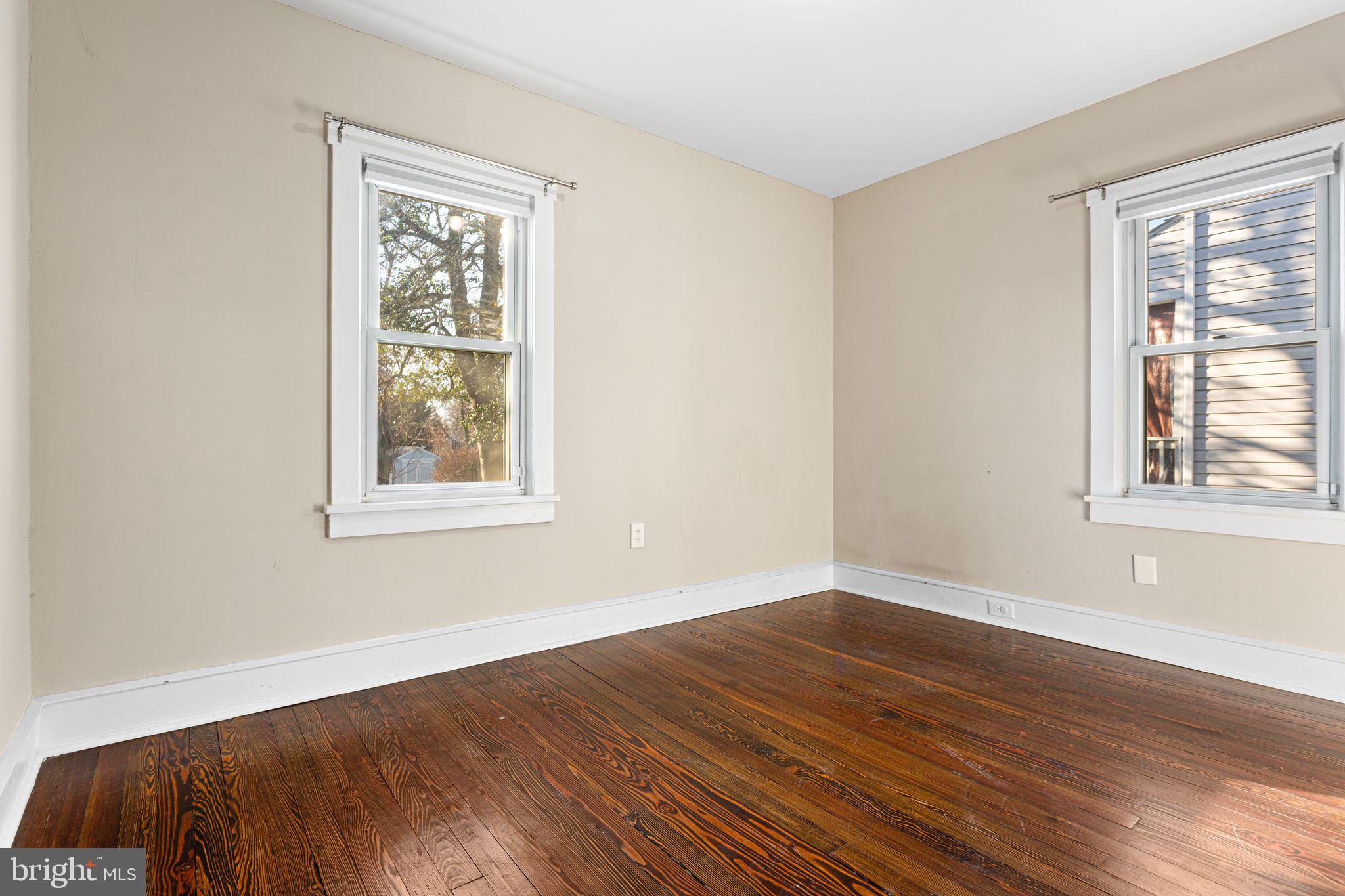 216 Richey Avenue Collingswood, NJ 08107 - Photo 16 of 39 a view of an empty room with wooden floor and a window