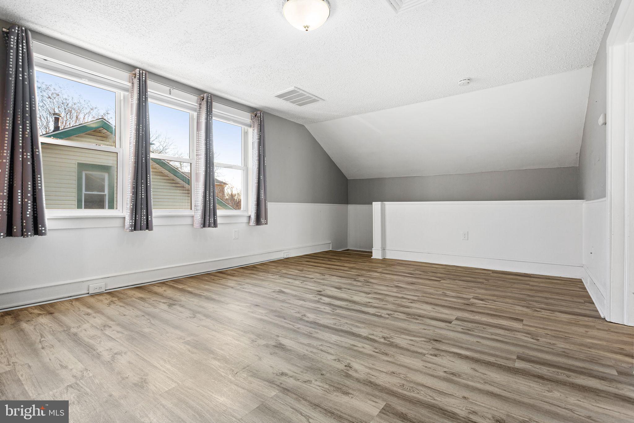 216 Richey Avenue Collingswood, NJ 08107 - Photo 19 of 39 a view of an empty room with a window and wooden floor