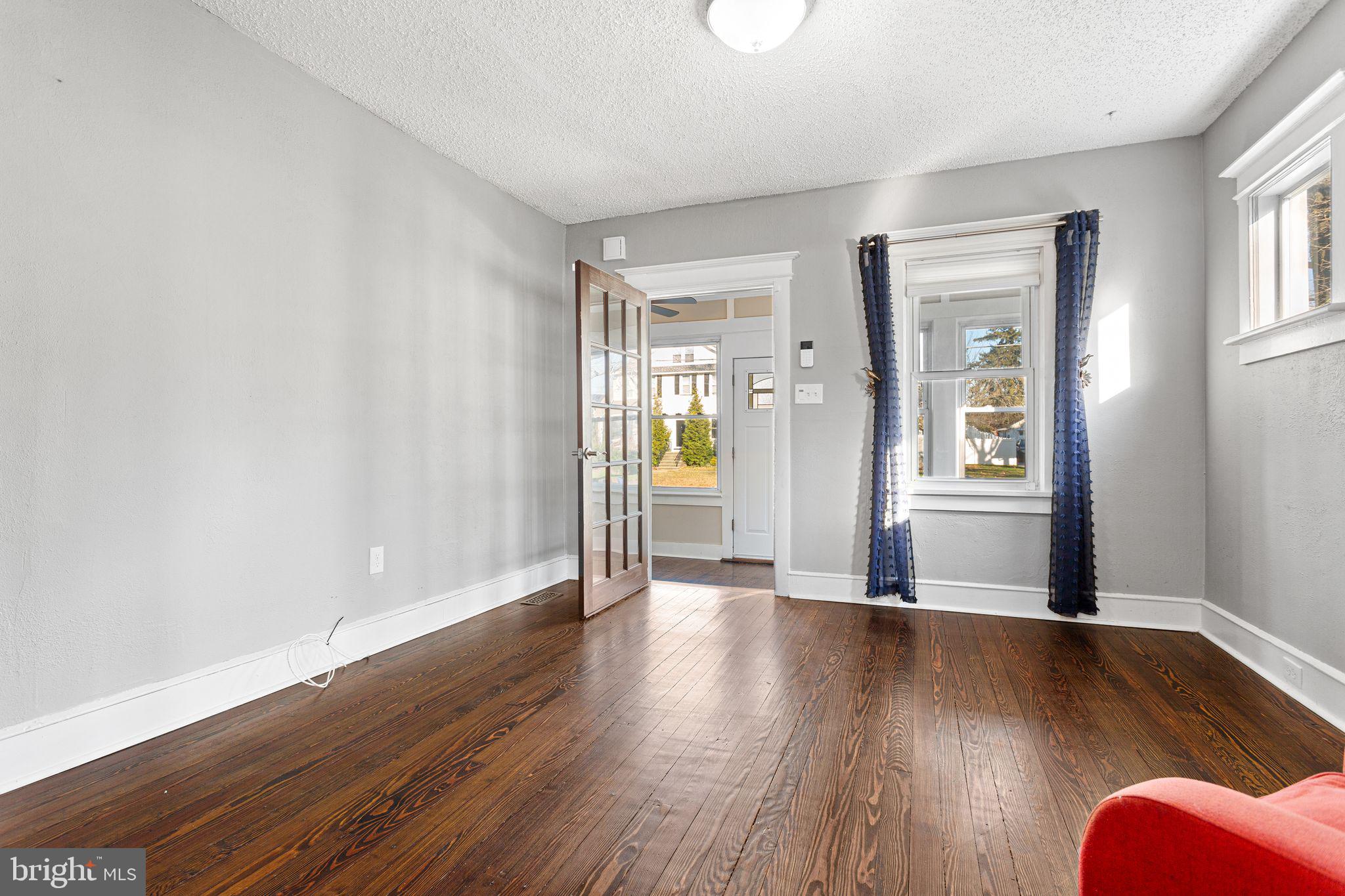 216 Richey Avenue Collingswood, NJ 08107 - Photo 5 of 39 an empty room with wooden floor and windows