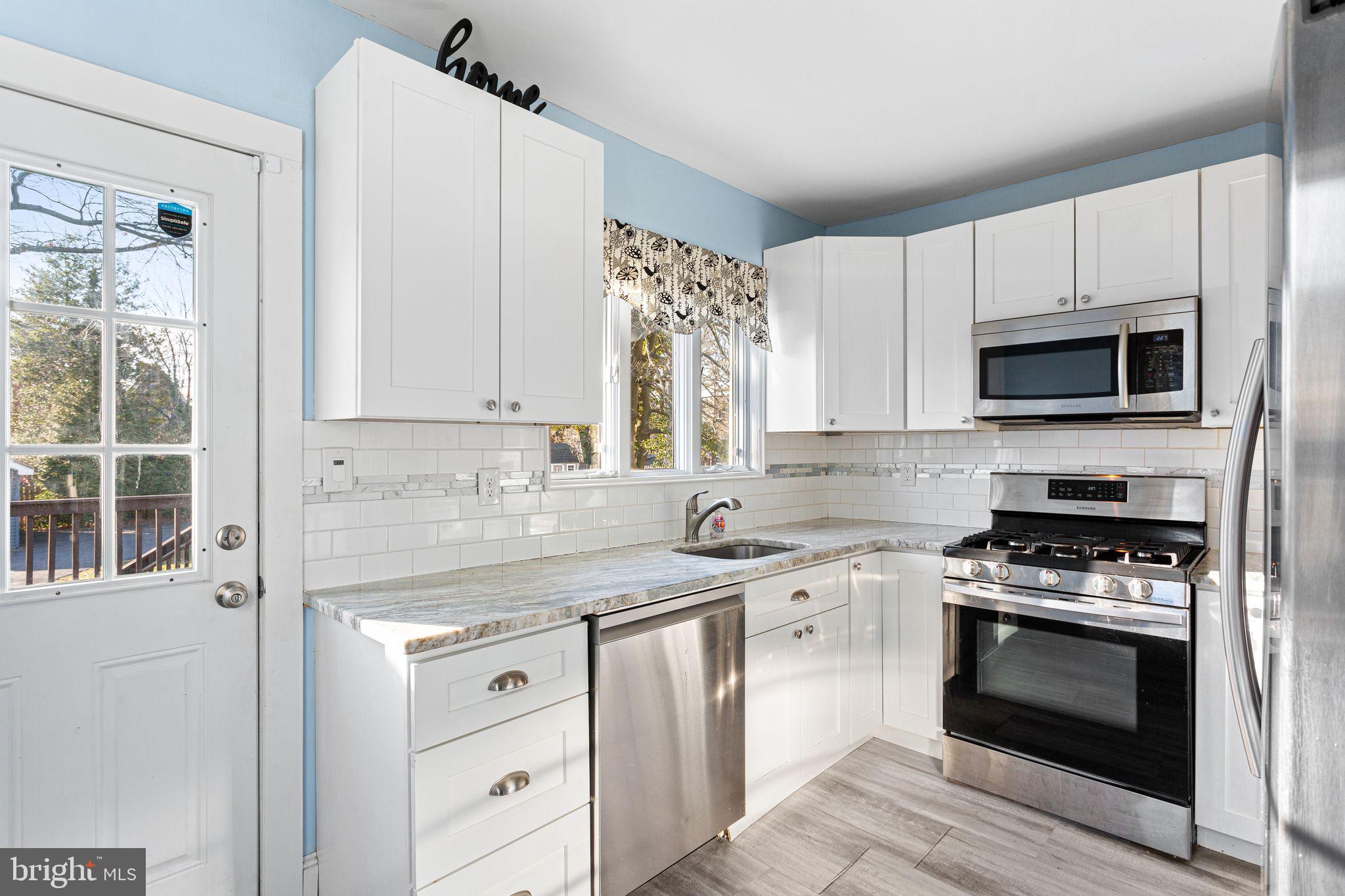 216 Richey Avenue Collingswood, NJ 08107 - Photo 9 of 39 a kitchen with cabinets stainless steel appliances and a counter space
