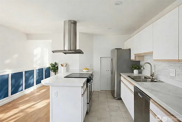 a kitchen that has a sink a refrigerator and a stove