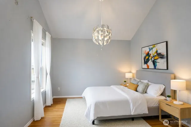 a bedroom with a bed and a chandelier