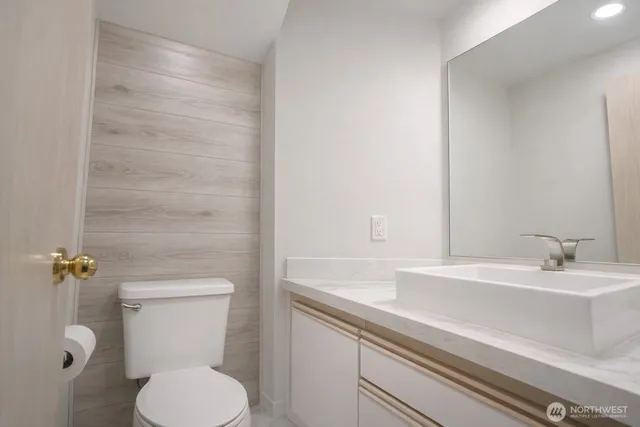 a bathroom with a sink a toilet and mirror