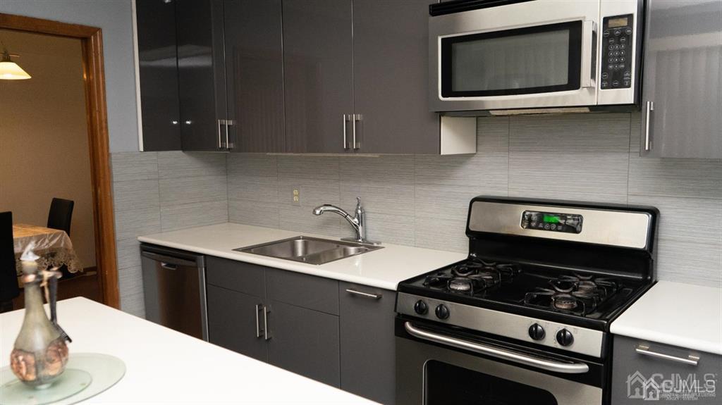 14 Winthrop Road Edison, NJ 08817 - Photo 3 of 28 a kitchen with a stove and a microwave