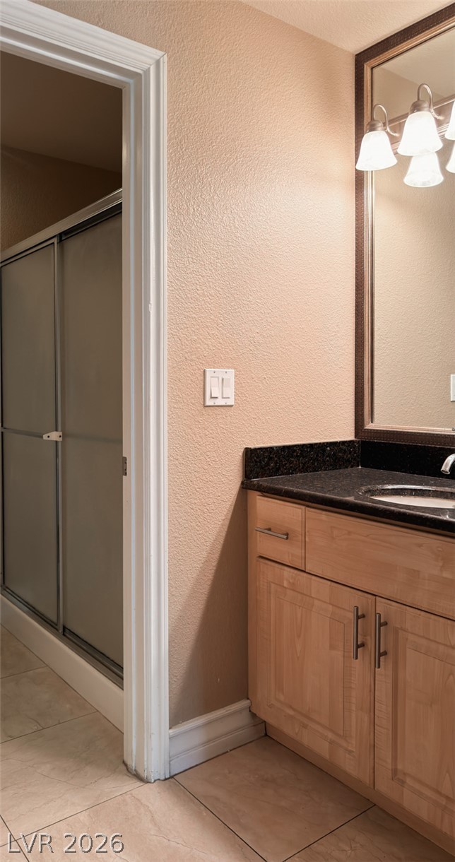 210 East Flamingo Road, Unit 112 Las Vegas, NV 89169 - Photo 19 of 59 Fine stone countertops and tiled flooring enhance this well-appointed washroom space.