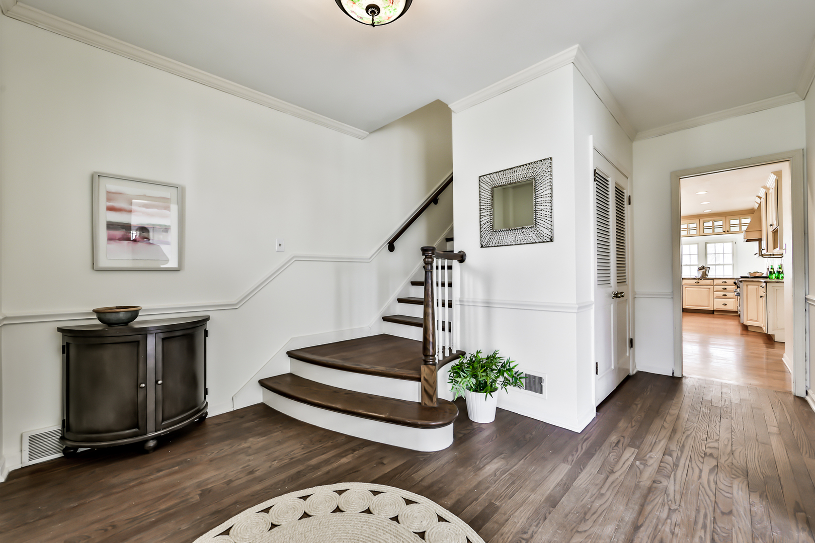 144 Michaux Road Riverside, IL 60546 - Photo 3 of 41 a view of a hallway with wooden floor stairs and a living room