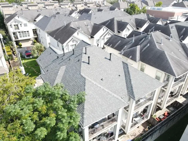 an aerial view of multiple houses with yard