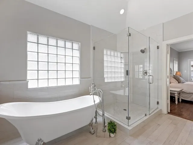 a bathroom with a bathtub and shower