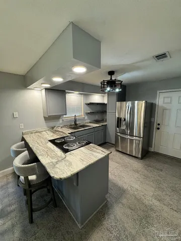 a kitchen with stainless steel appliances granite countertop a sink and a stove