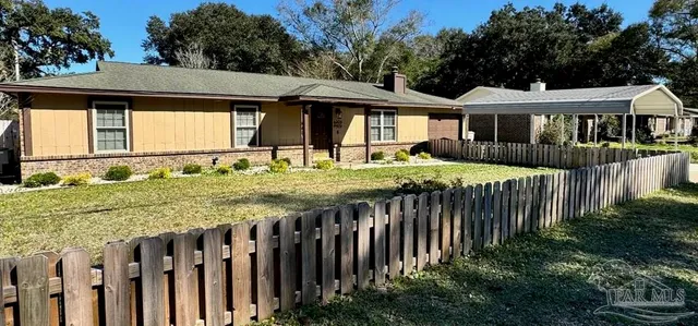 a front view of a house with a yard table and chairs