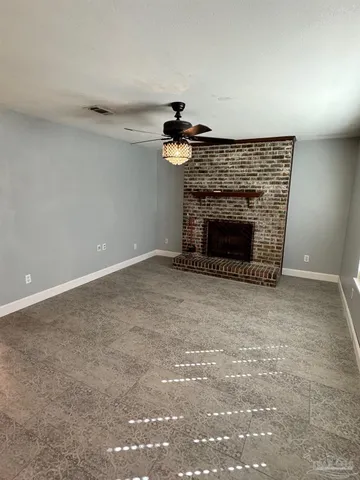 a view of empty room with fireplace