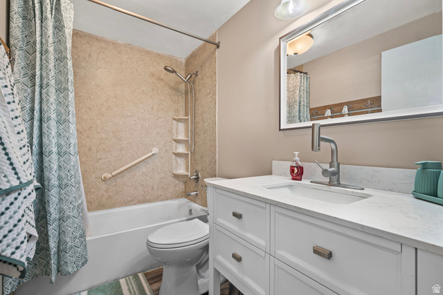 564 Swenson Avenue Springville, UT 84663 - Photo 10 of 26 Bathroom featuring a built-in tub with a textured surround, a white vanity with an integrated sink, a wall-mounted mirror, and a contemporary brushed nickel faucet