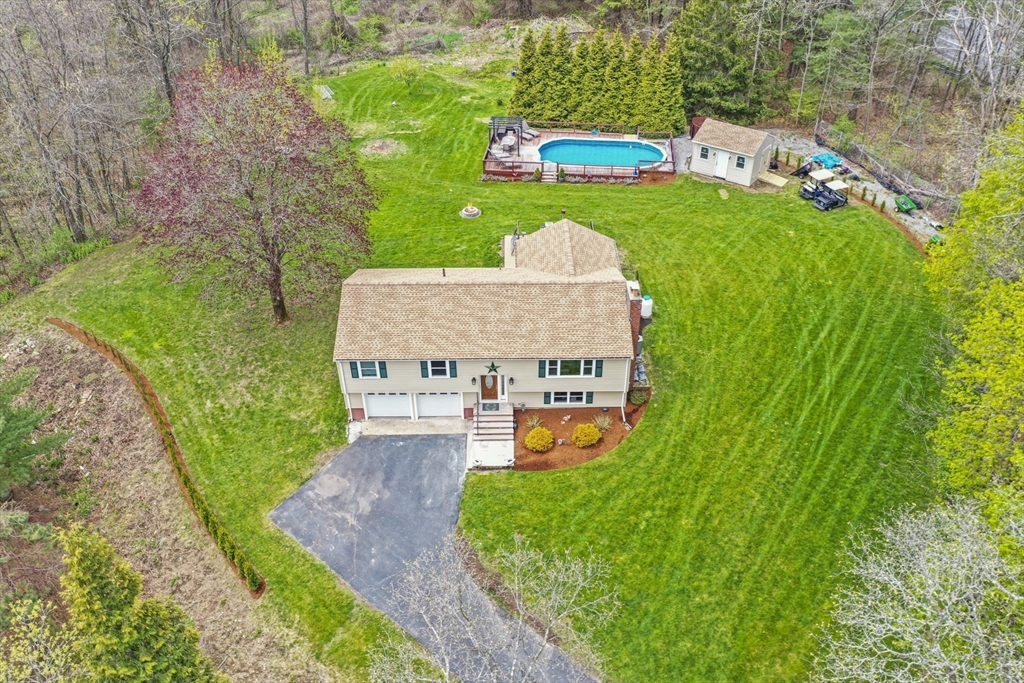 a aerial view of a house with swimming pool garden and patio