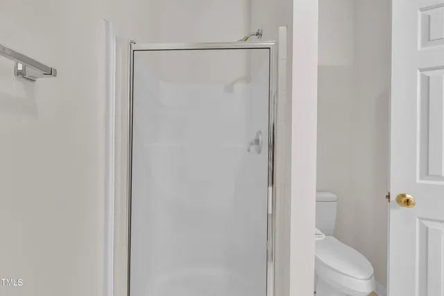 a bedroom with a large bed and potted plant